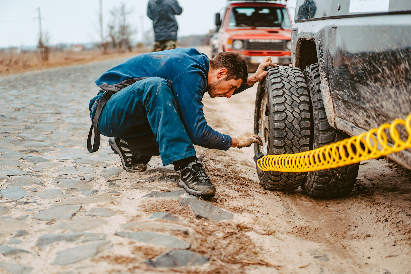 man-pumps-air-wheel-with-compressor.jpg