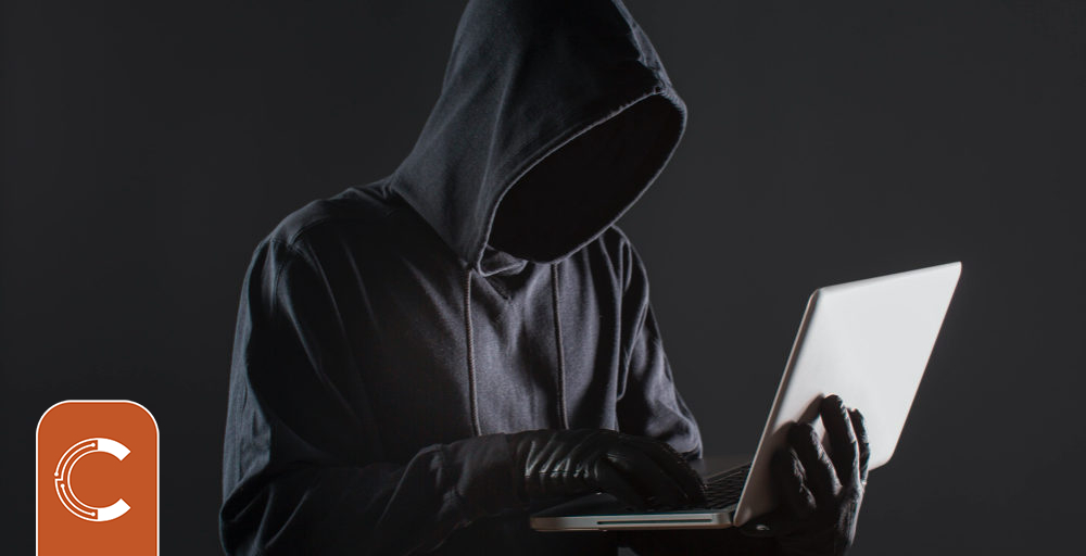 side-view-male-hacker-with-gloves-laptop-1000x512.jpg