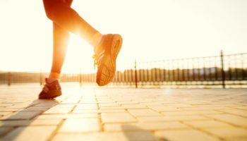 runner feet running road closeup shoe woman fitness sunrise jog workout welness concept