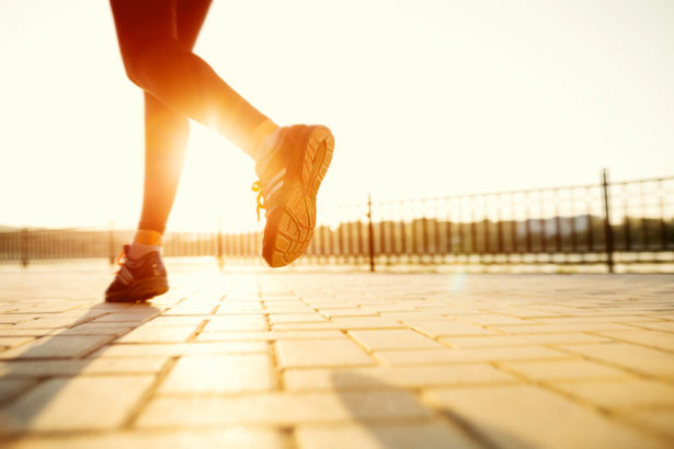 runner feet running road closeup shoe woman fitness sunrise jog workout welness concept