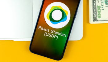 paxos standart usdp coin symbol trade with cryptocurrency digital virtual money banking with mobile phone concept business workspace table with laptop top view photo