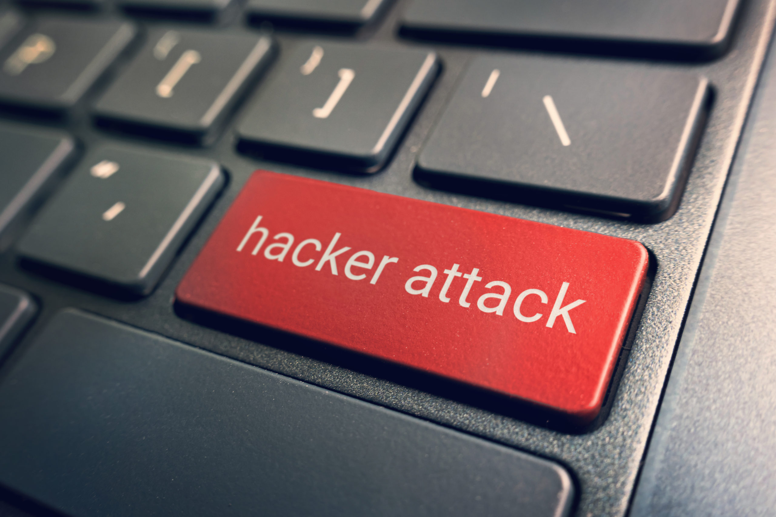 closeup view conceptual keyboard hacker attack red keys laptop keyboard blurred background