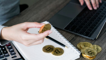 laptop with calculator golden bitcoin cryptocurrency investors concept