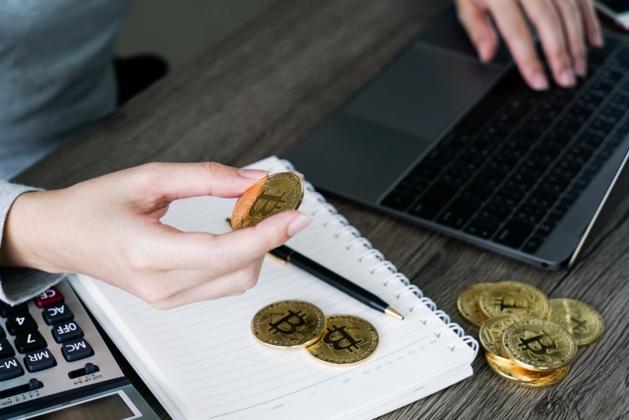 laptop with calculator golden bitcoin cryptocurrency investors concept