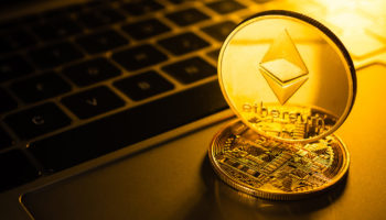 Golden coins with ethereum symbol on computer.
