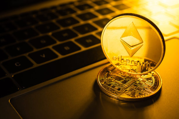 Golden coins with ethereum symbol on computer.