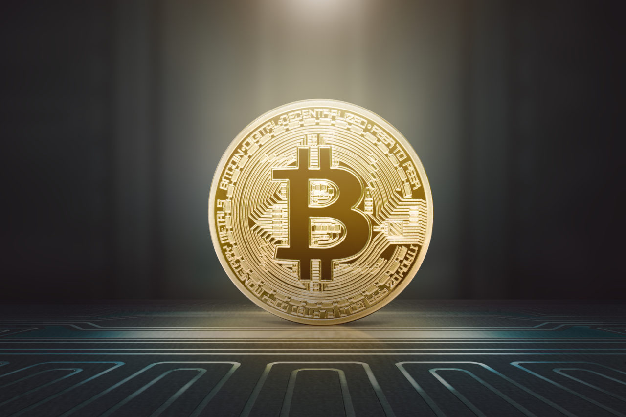 Golden bitcoin standing on electrical circuit